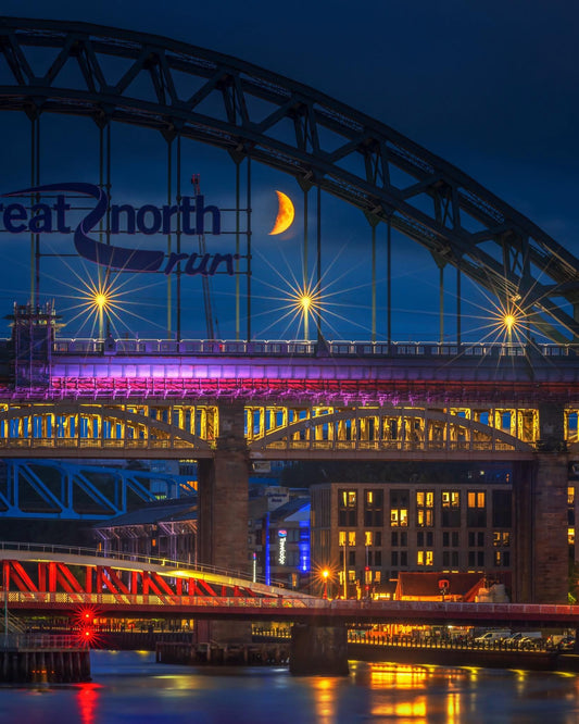 Crescent moon caught in the bars of the Tyne Bridge.