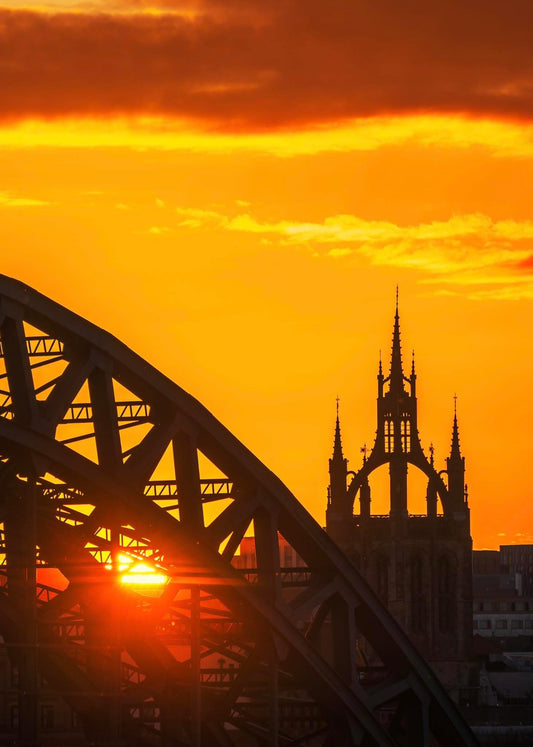Tyne Bridge and Newcastle Cathedral at sunset.