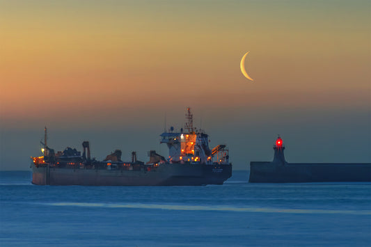 A fishing boat and a crescent moon above the lighthouse.