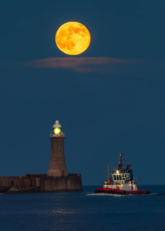 Full moon, a lighthouse and a boat.