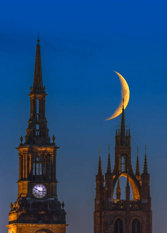 A waxing crescent moon over Newcastle Cathedral.