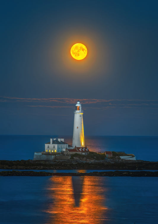 The full moon rising high above St. Mary’s Lighthouse.