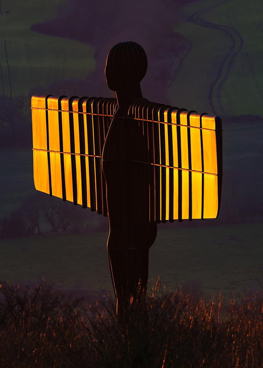 The Angel of the North with the setting sun lighting up her wings.