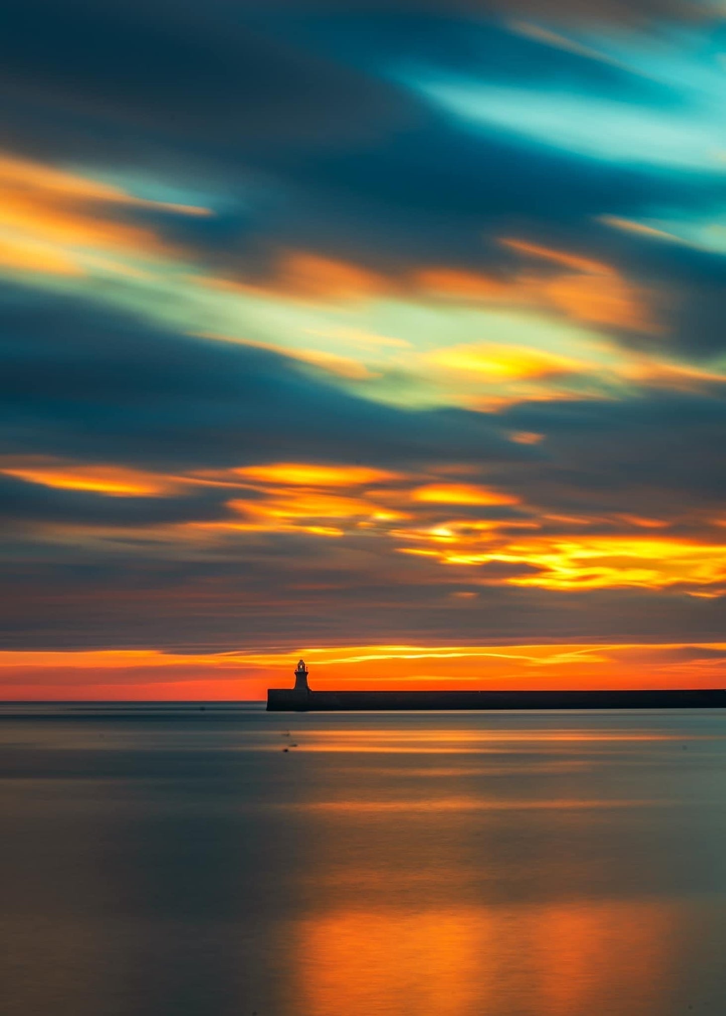 Long exposure of a colourful sky looking towards South Shields lighthouse.