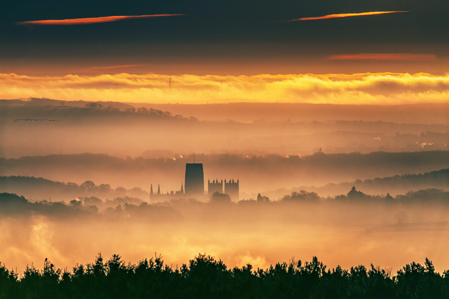 Early morning shot of Durham cathedral with mist and birds.