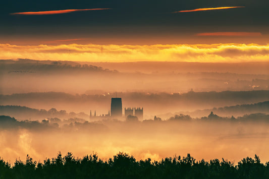 Early morning shot of Durham cathedral with mist and birds.