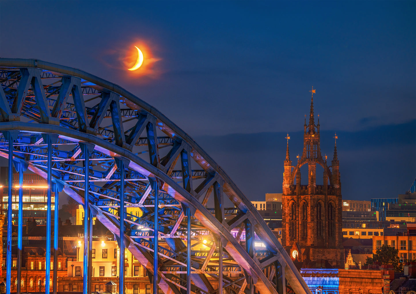 A crescent moon hanging above the Tyne Bridge.