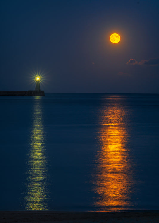 Tynemouth lighthouse and full moon reflections