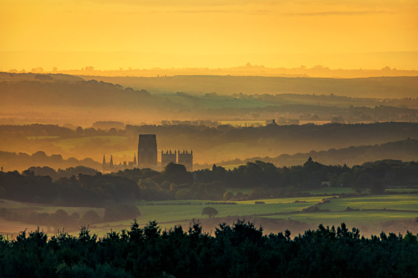 The early morning golden glow of the sun rising above Durham Cathedral